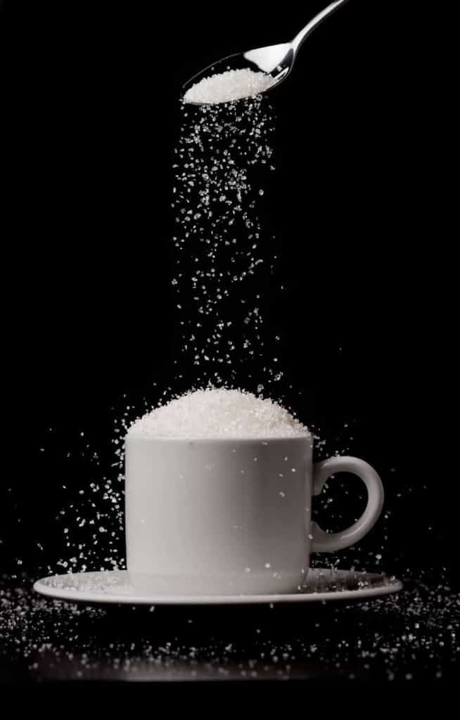 Coffee cup with sugar raining down.