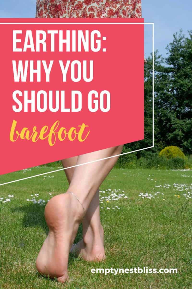 Barefoot girl walking away on grass
